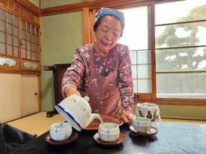 Japanse vrouw schenkt thee in