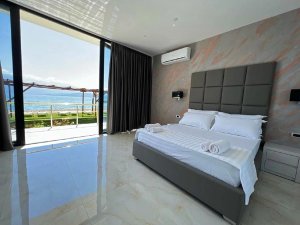 Moderne slaapkamer bij het Ohridmeer in Noord-Macedonië met groot bed, balkon en uitzicht op het meer